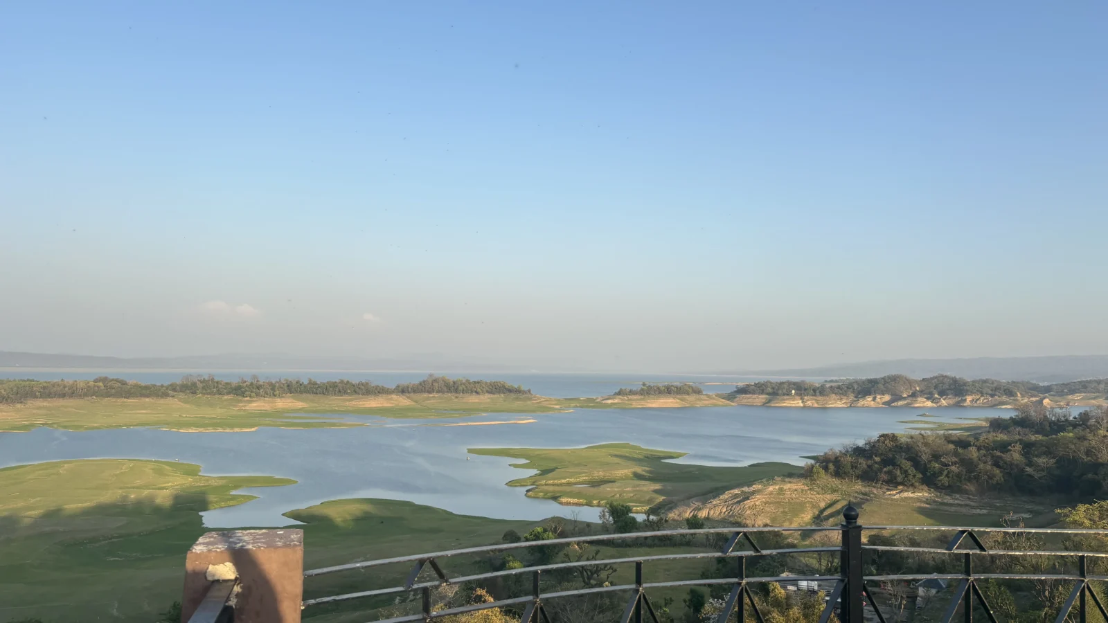The Pong reservoir seen from the terrace at Lodge at Pong, Dhameta, with grass islands standing above the waterline
