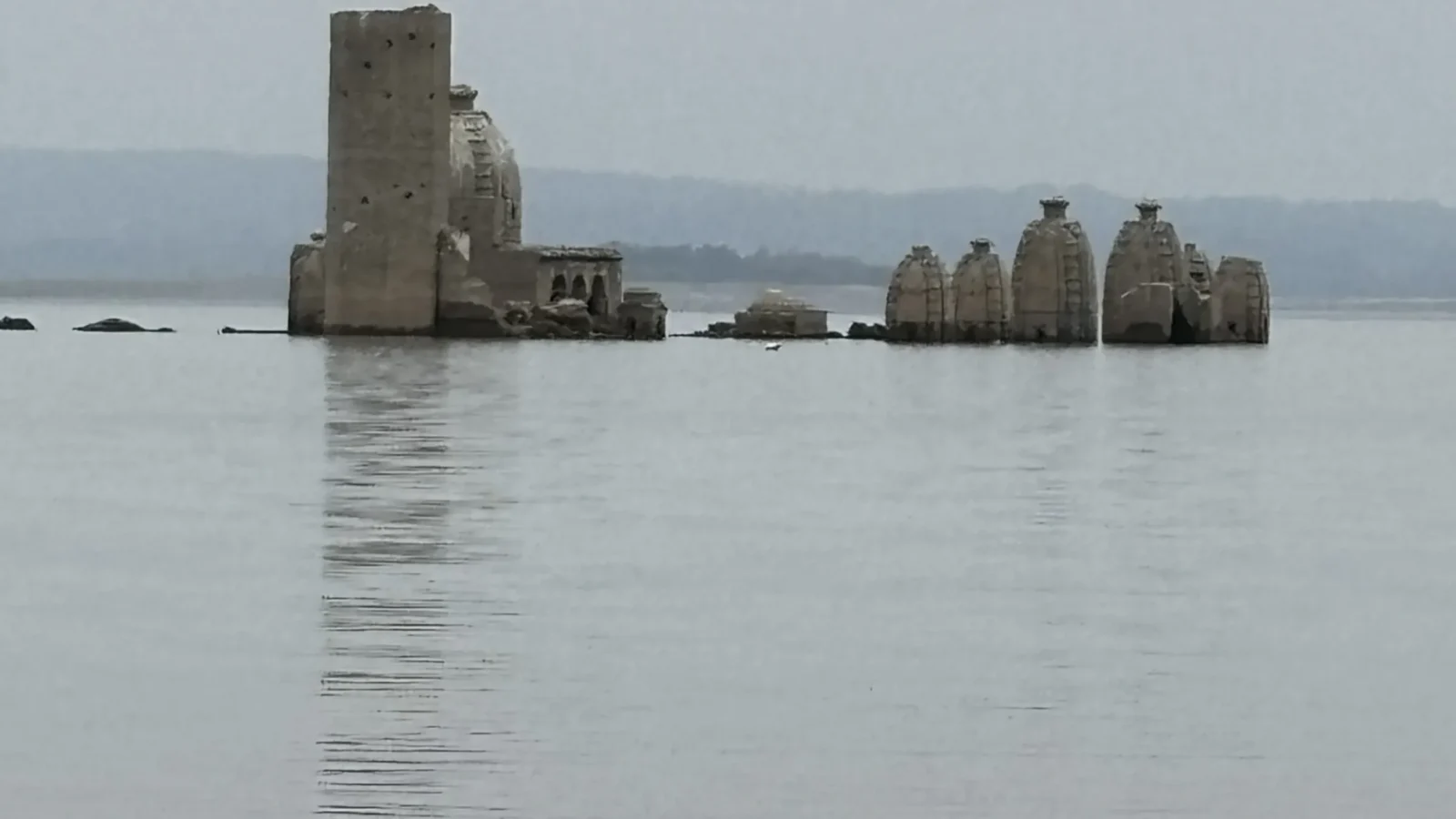 The Bathu ki Ladi temples standing in the water of the Pong Dam reservoir, Kangra